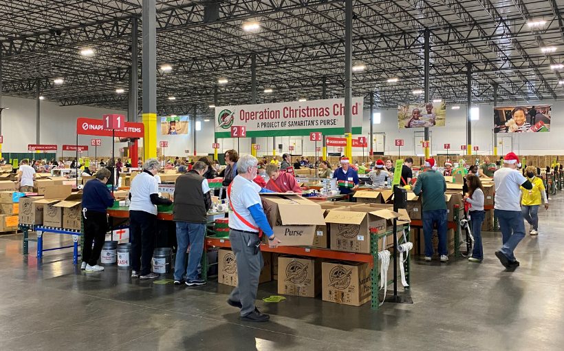 Operation Christmas Child volunteers prepare shoeboxes of gifts and personal notes