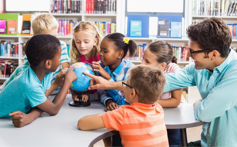 Students and teacher with a globe