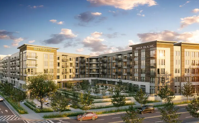Exterior rendering of luxury apartment building with large windows and balconies, and pool area