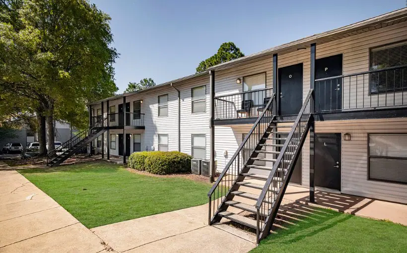 Exterior view of Grayton on Dean, a two-story garden apartment building with vinyl paneling and outside stairs and unit entrances