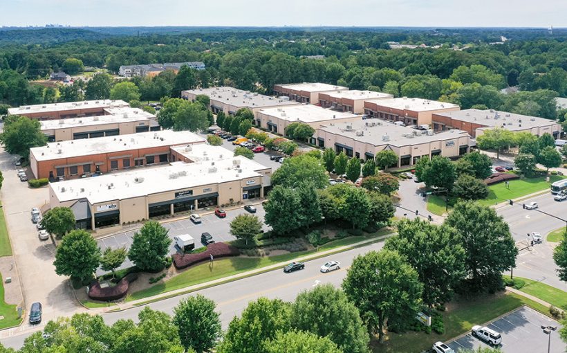 An aerial view of a nine, single-story buildings with loading docks for trucks and shop/office space.