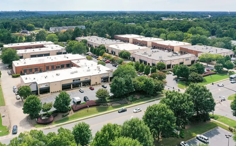 An aerial view of a nine, single-story buildings with loading docks for trucks and shop/office space.
