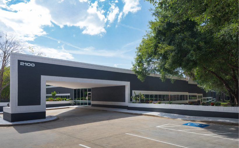Exterior of an industrial building of modern design with a large protective overhang attached to the entrance