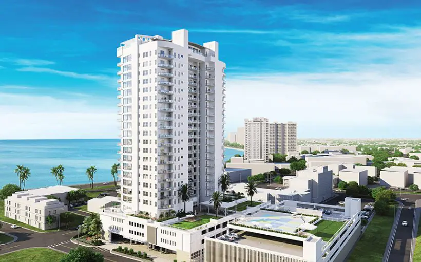 Long-range view of high-rise building with Tampa Bay waters behind it.