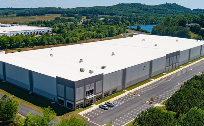 Aerial view of a large industrial building with entrance in front left corner