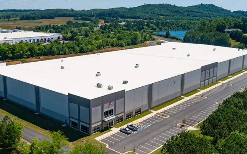 Aerial view of a large industrial building with entrance in front left corner