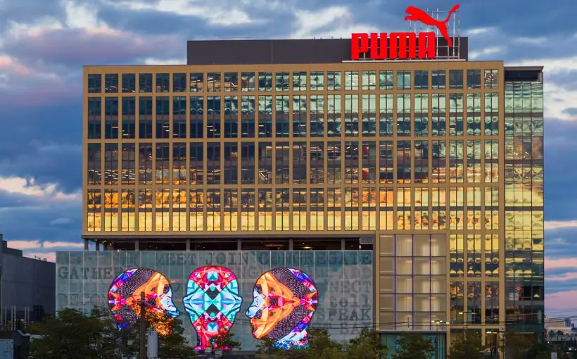 Exterior view of window-filled office building reflecting sunset