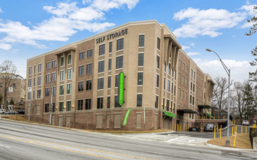 Mid rise urban building with entrance awnings and corporate color signage and awnings