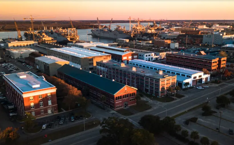 Construction has begun redevelopment of two historic storehouses in North Charleston, SC as part of transformation of the former Naval Base into a mixed-use neighborhood.
